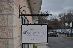 Columbia Wayfinding Signs outdoor hanging blade sign blue sea building business wayfinding address sign 300x199
